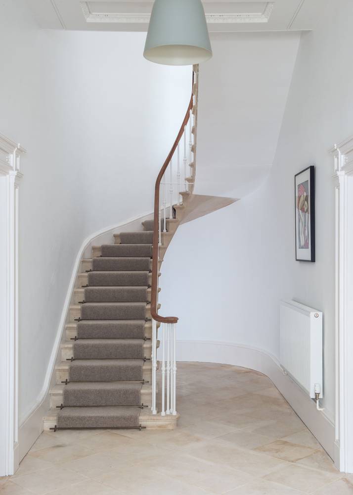 <p>The lower part of this sweeping cantilevered stone stair had been crudely broken out when the building was subdivided into flats. The bottom 14 steps were painstakingly reinserted from the top down in order to tie into the existing stair.&nbsp;</p>